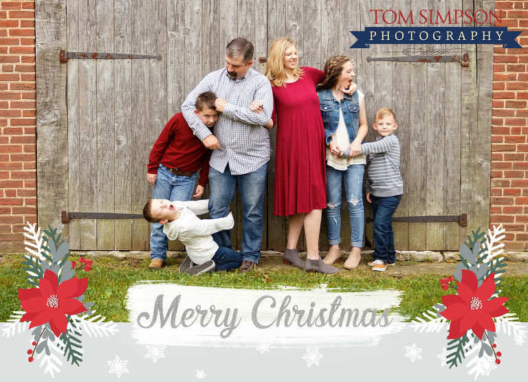 family silliness during photo session by barn