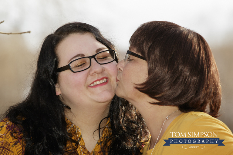 mother kissing daughter fall photography