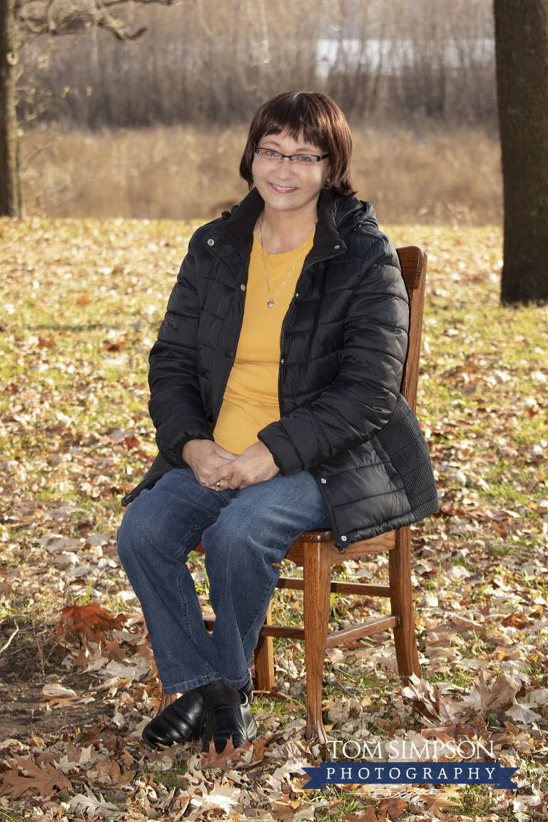 fall leaves surrounding mother on chair
