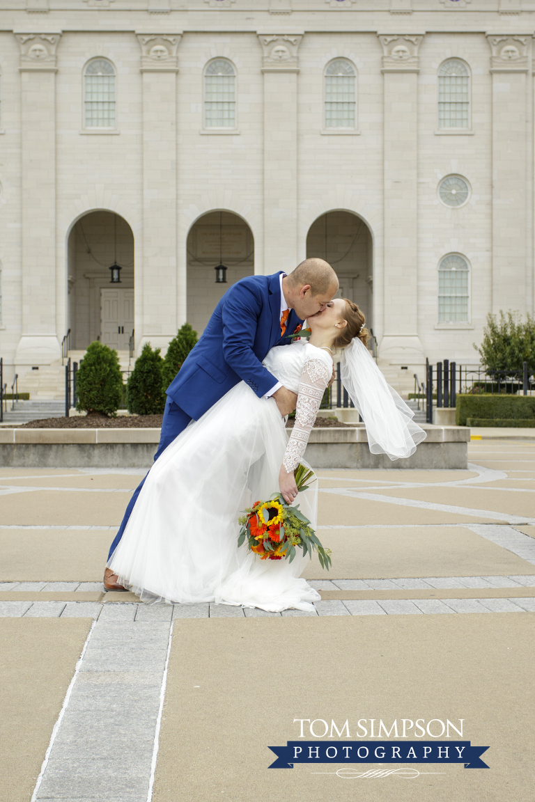 groom kissing bride nauvoo temple arches