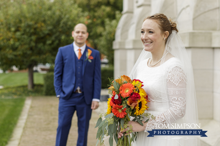 bride fall bouquet groom in blue