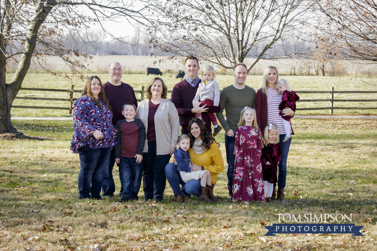 family portrait outdoor cows split rail fence