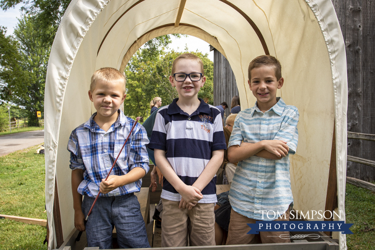 three boys covered wagon