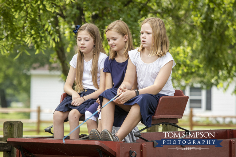 three girls buckboard wagon seat